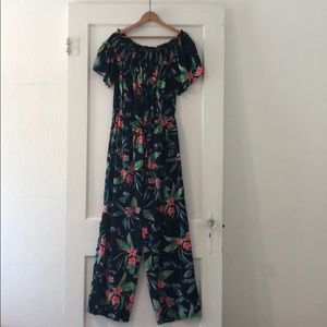 Hint of Blush romper. Navy with tropical print. 1X